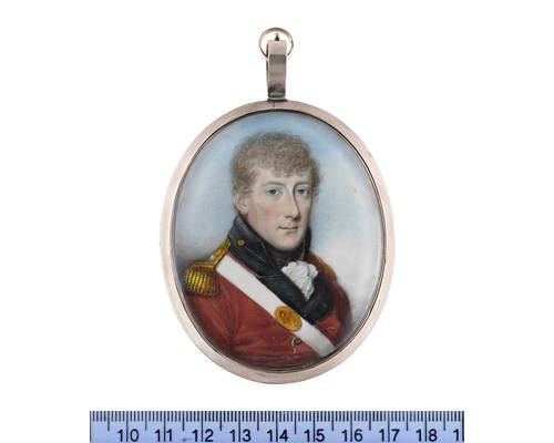 An Officer, wearing red coat with black facings and standing collar, gold buttons and epaulettes, white cross belt with oval gilt-metal belt plate engraved SMR, white frilled chemise and black stock