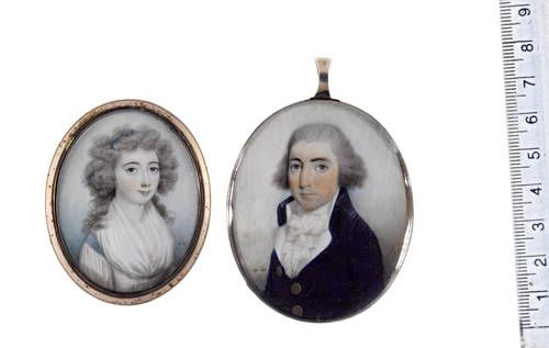 Two portraits of a Lady and a Gentleman; she, wearing blue trimmed white dress and white fichu, her powdered wig dressed with a blue bandeau; he, wearing, blue coat, white waistcoat, frilled chemise, stock and cravat, powdered wig.