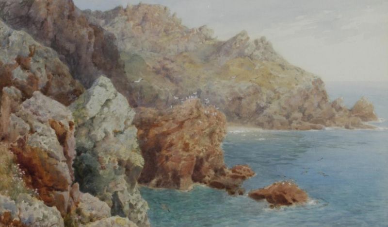 A rocky coastline, possibly in the Channel Islands